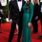 Brad Pitt and Angelina Jolie; Jolie is wearing Versace